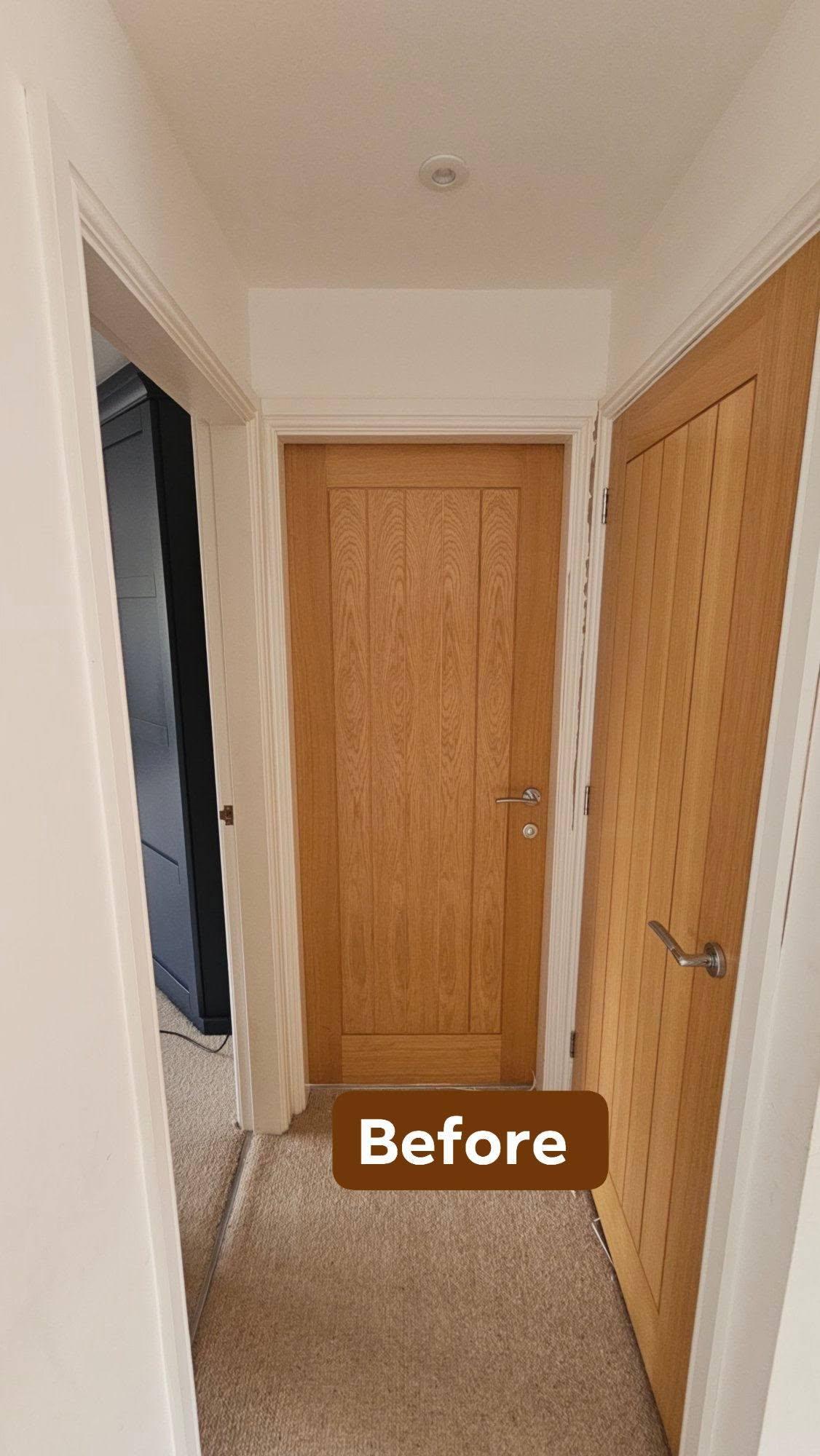Upstairs hallway before, plain white walls and oak doors