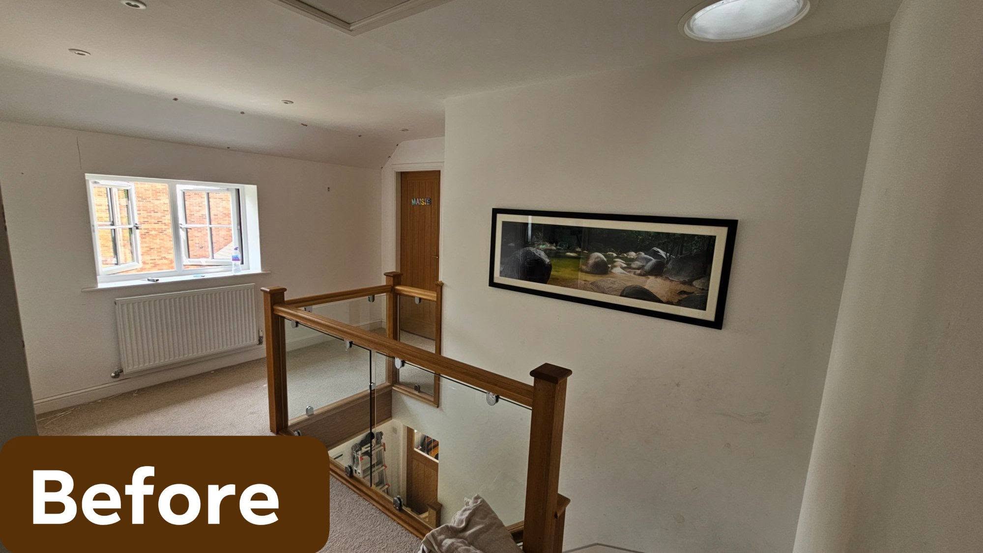 Landing before: scuffed white walls around the oak and glass balustrade