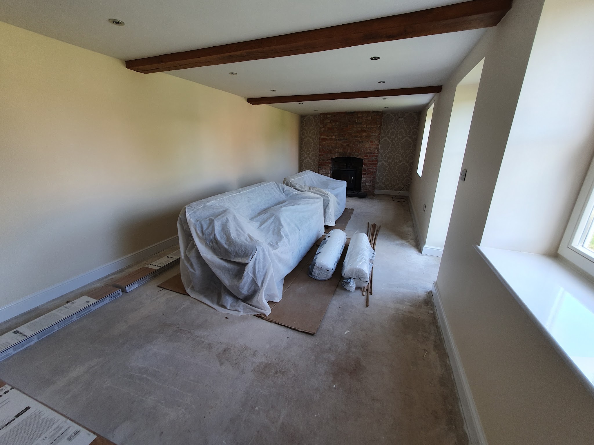 Beamed lounge mid-job with the sofa under dust sheets